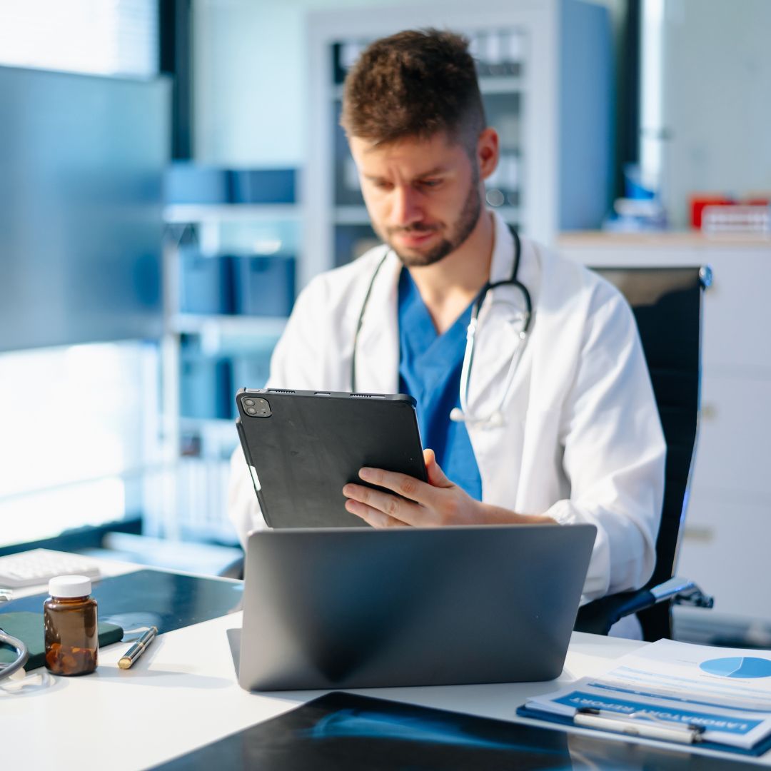 EKG tech looking at a tablet