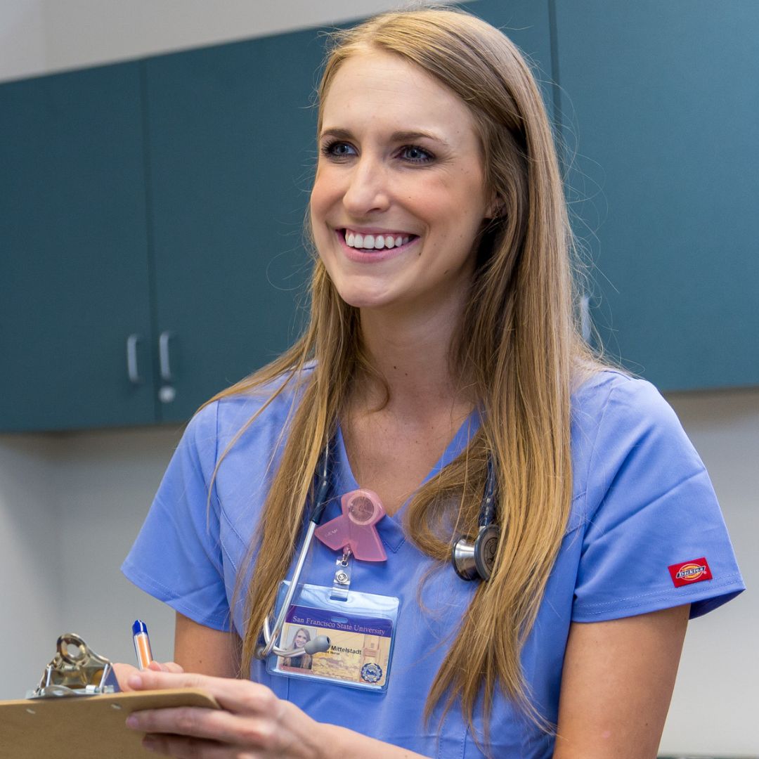 Family Nurse Practitioner smiling and wearing scrubs