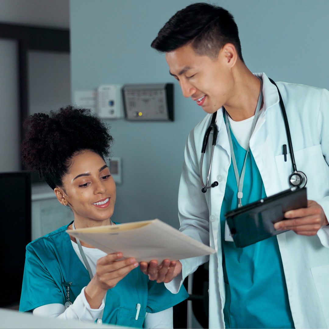 Medical administrative assistant shows a file to a doctor