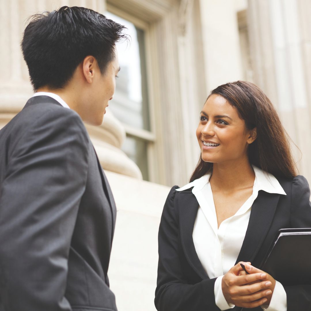 Paralegal and attorney speak outside of a courthouse