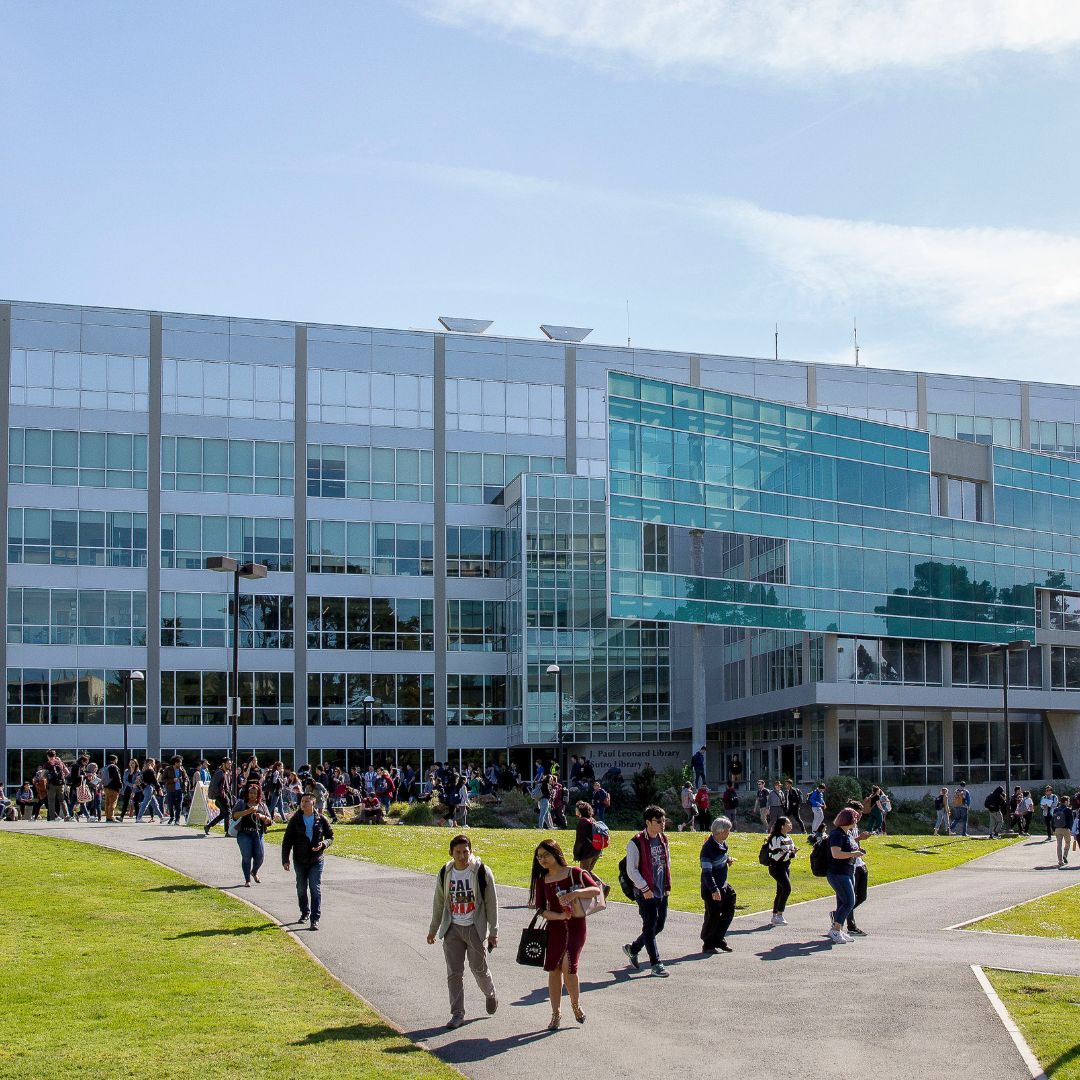 Students walking in front of library form a V shape