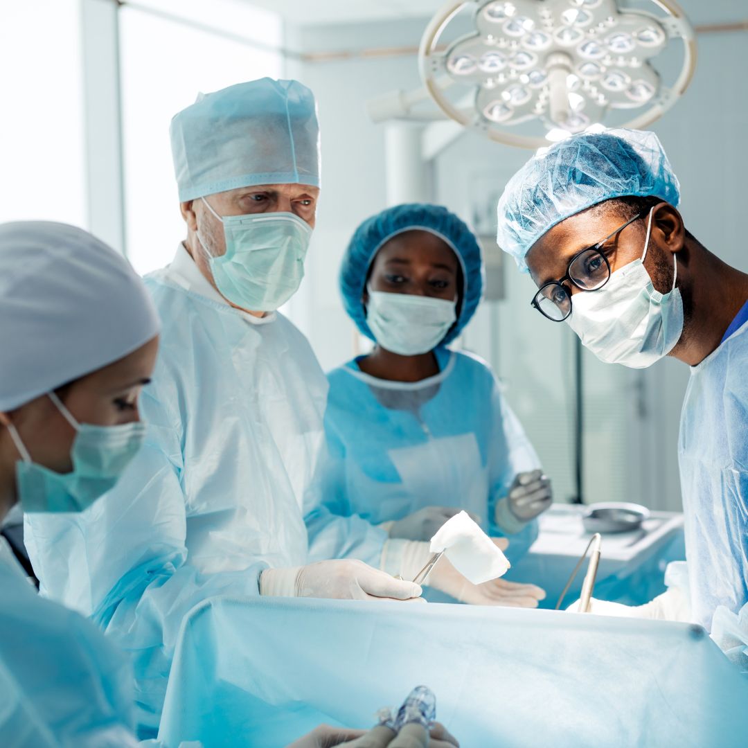 Surgical technician at work in the operating room with doctors and nurses
