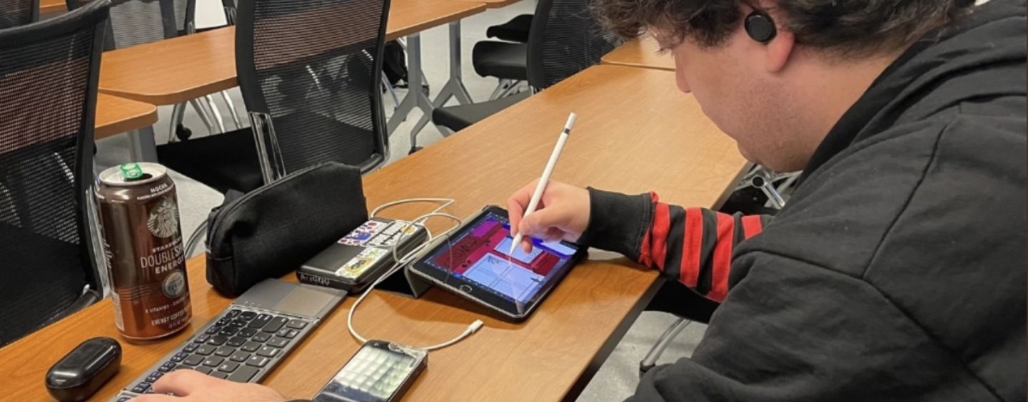 Auggy Garcia drawing in class at SF State