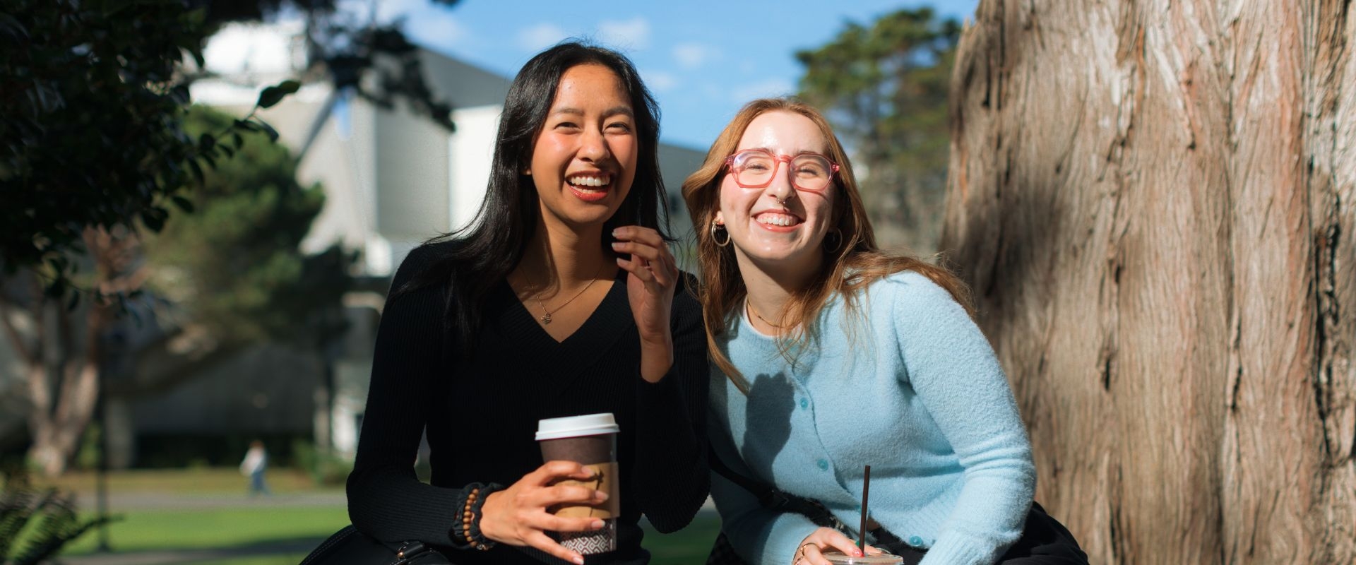Two women laugh together on the SFSU campus