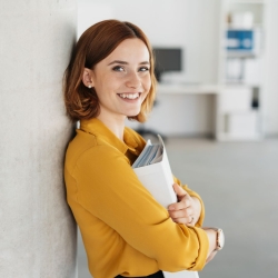 Business degree student holding schoolwork