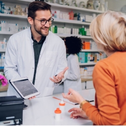 Pharmacy technician helping a customer