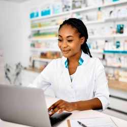 Pharmacy tech on the computer at work