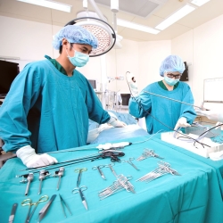 Sterile processing technician in the operating room with sterilized tools