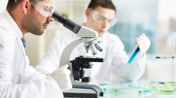 Clinical lab scientist using microscope