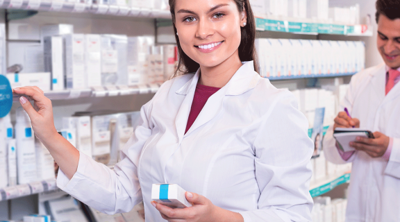 Pharmacy technician by the shelves